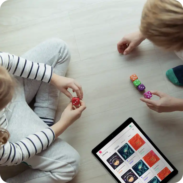 Kids on floor with iPad and toys